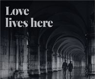 Love Lives Here Couple Walking Under Stone Arches
